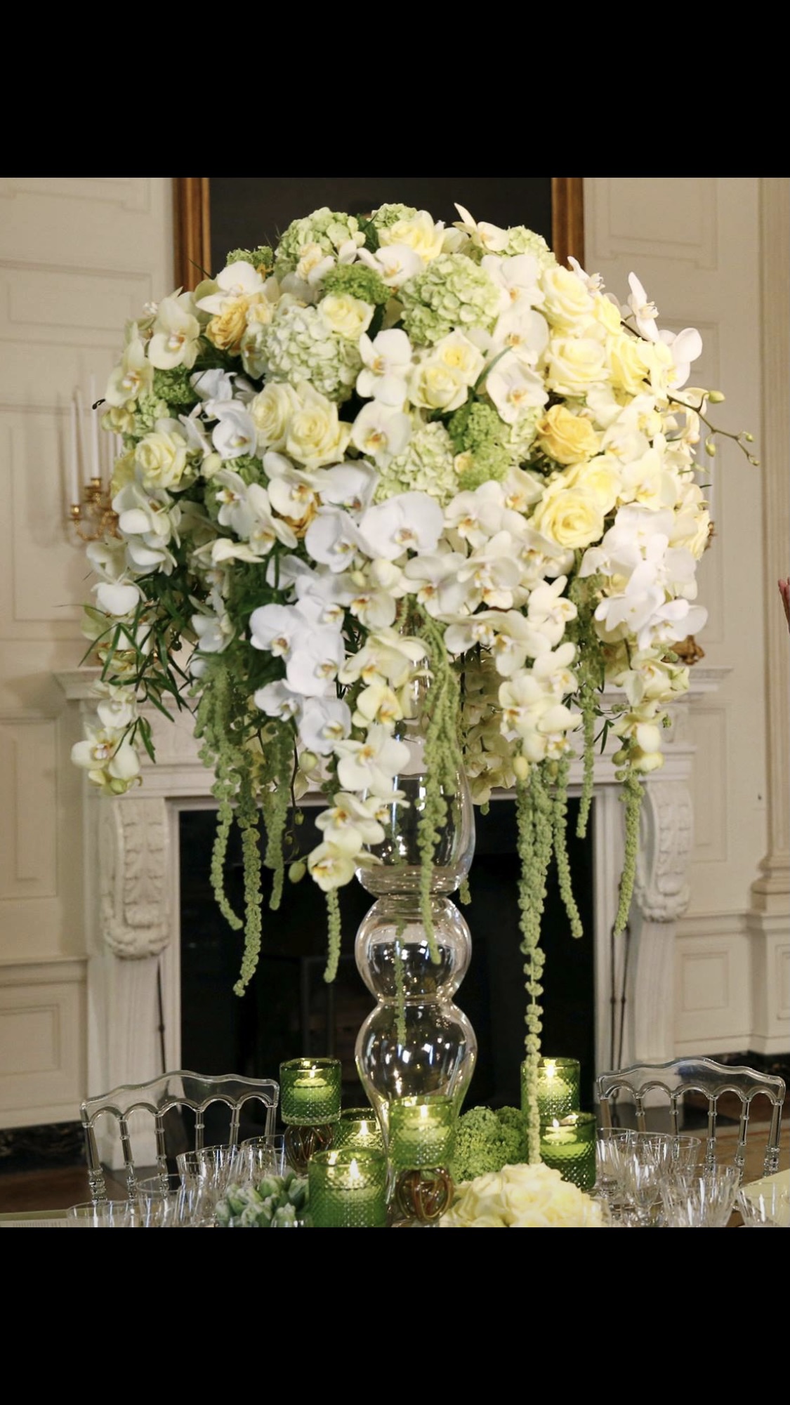 A large vase filled with flowers on top of a table.