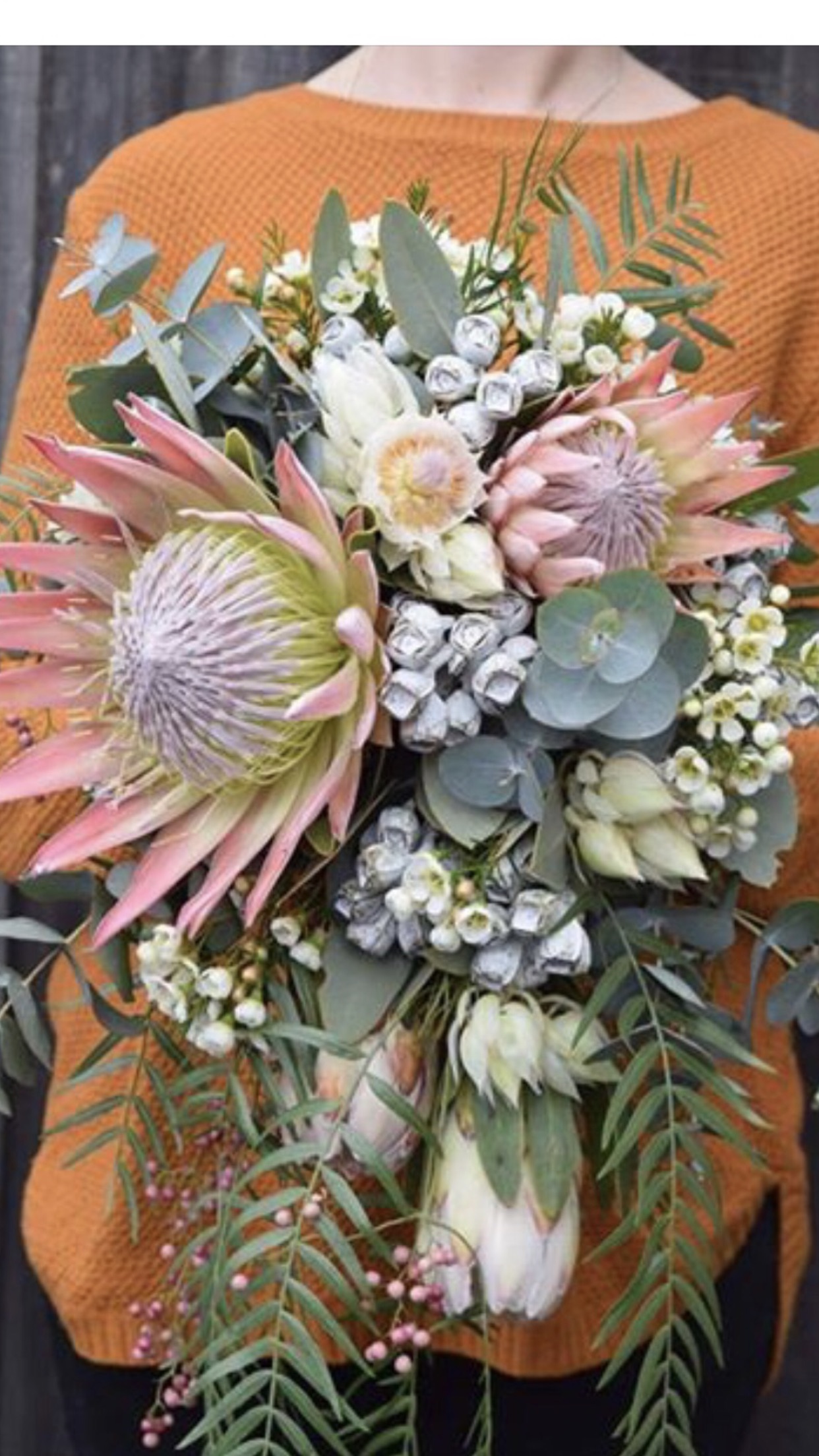 A bouquet of flowers with various types of foliage.