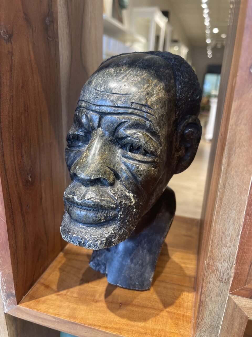 A bust of an african american man in a room.