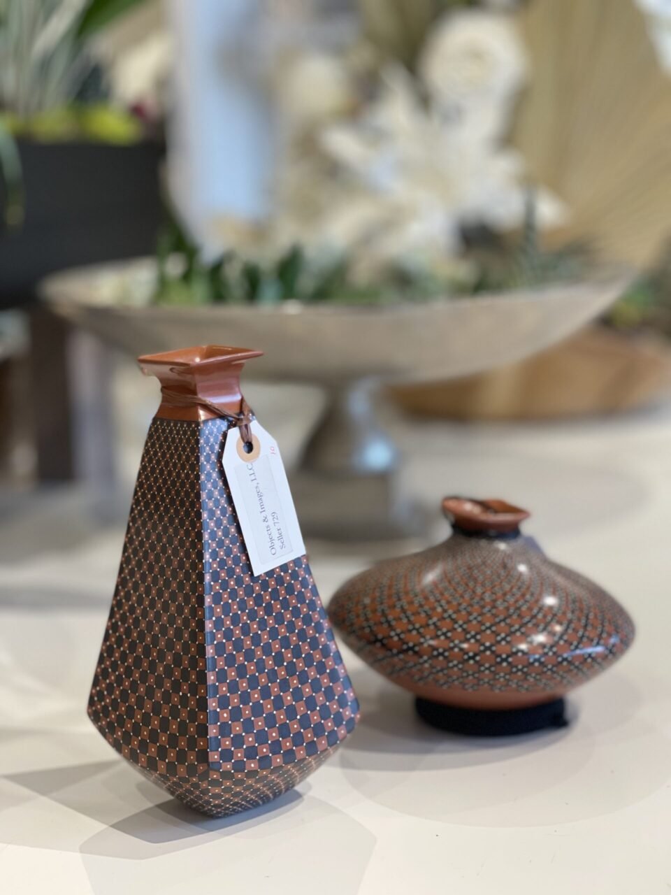 Two brown vases sitting on top of a table.
