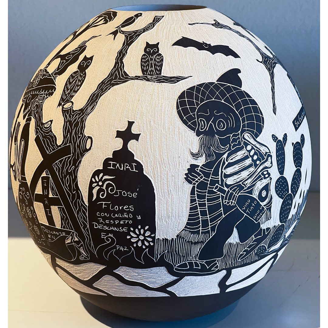 A black and white pumpkin with a witch on it