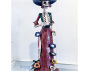 A skeleton wearing a hat and dress