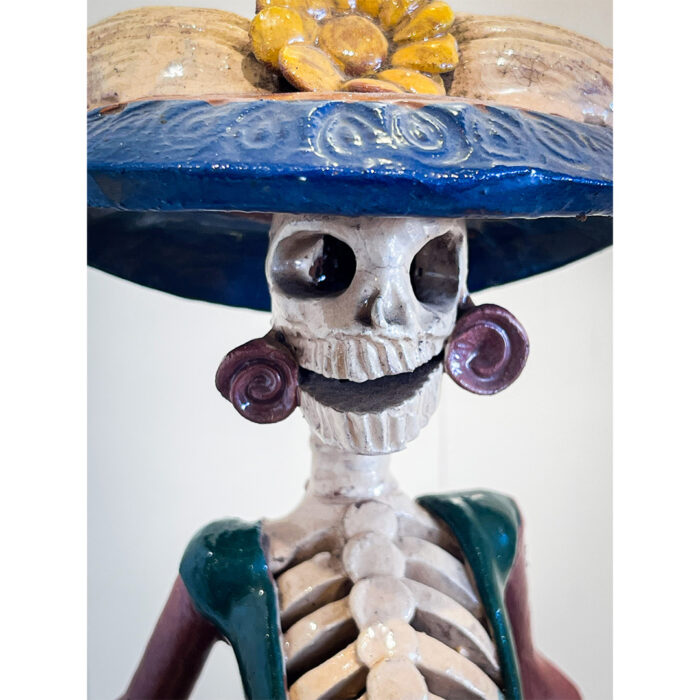 A skeleton with a hat on top of it.