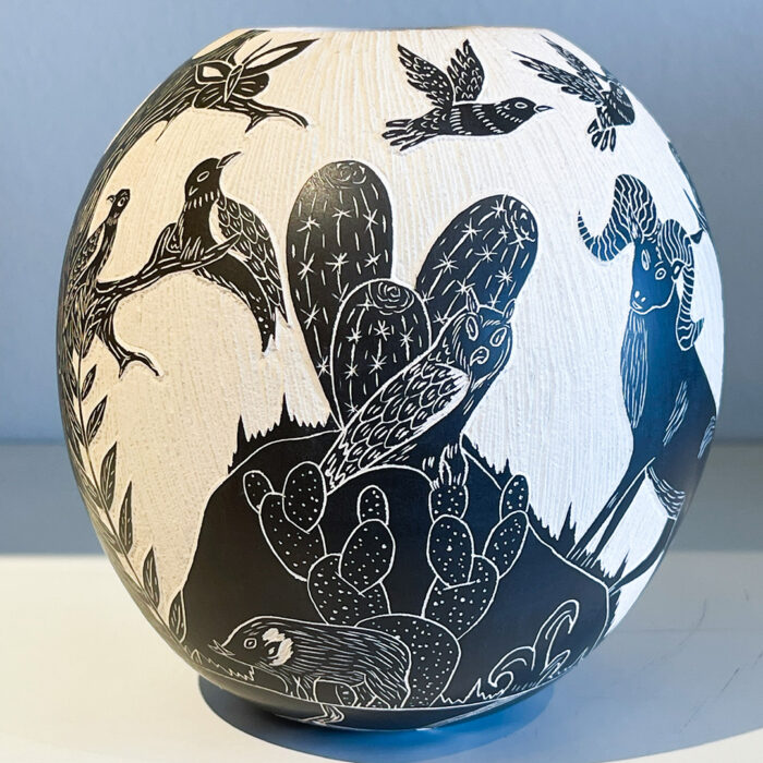 A black and white vase with birds on it