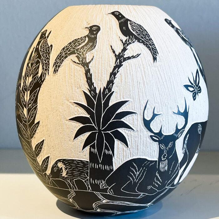 A black and white vase with animals on it